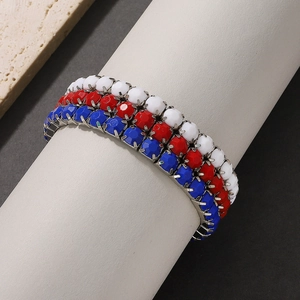 Detail of multi-row faceted red white and blue beads with silver metal chain setting