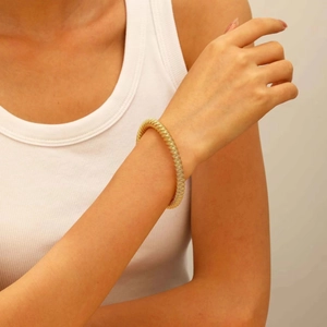 Close-up of golden multi-layer elastic coil bracelet with vintage textured design