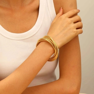 Close-up of golden multi-layer spiral cuff bracelet with fine textured metal finish