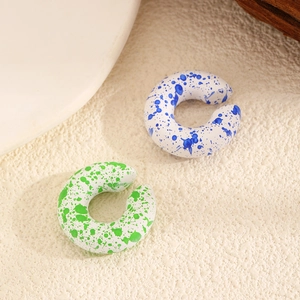 Artistic resin hoop earrings with blue and green ink splatter texture detail