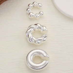 Three-piece silver ear cuff set with beaded, twisted, and ribbed textures for non-pierced ears