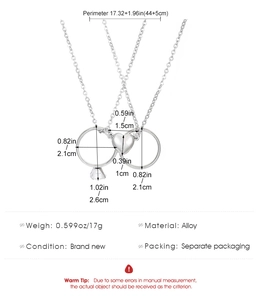 Detailed view of couple necklaces set with magnetic heart pendant and ring charms