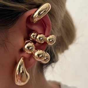 Polished gold hollow teardrop and spherical cuff earrings set for a bold fashion look