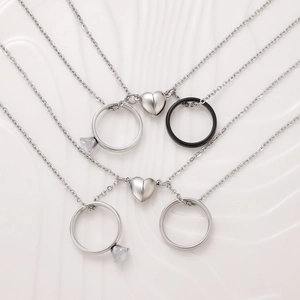 Minimalist magnetic couple necklaces with ring pendants and heart connection in silver