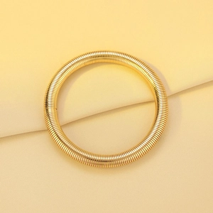 Detailed close-up of golden multi-layer stretch bracelet with a vintage textured surface
