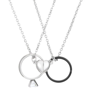 Detail view of magnetic heart couple necklaces with silver ring and black ring pendant