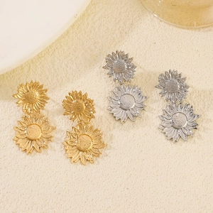 Close-up of vintage metallic sunflower earrings featuring layered gold and silver petals