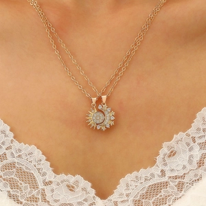 Detailed view of rose gold sun and moon pendant necklaces with sparkling zircon inlay