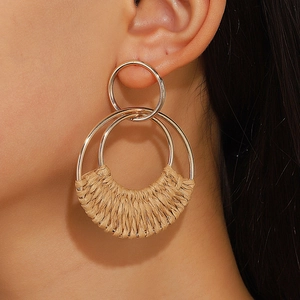 Bohemian double hoop earrings featuring woven raffia details and polished gold metal