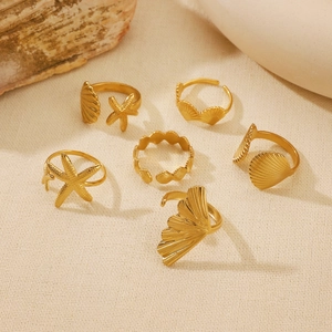 Set of 6 gold starfish and seashell adjustable rings featuring delicate ocean motifs