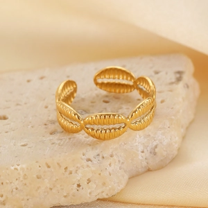 Macro detail of adjustable gold starfish seashell ring on elegant stone background