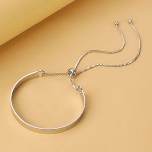 Close-up of minimalist silver leaf bracelet with adjustable sliding bead and chain