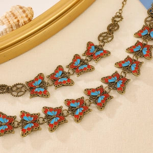 Vintage steampunk butterfly necklace with bronze gears and red-blue enamel wings