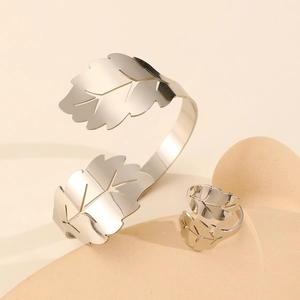 Macro shot of silver dual-leaf adjustable cuff bracelet and ring set in polished finish