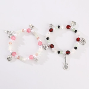 Magnetic beaded couple bracelets with strawberry charms and silver heart connection