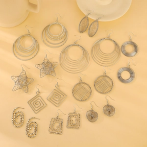 Collection of silver geometric hollow round earrings with various metallic cutout designs