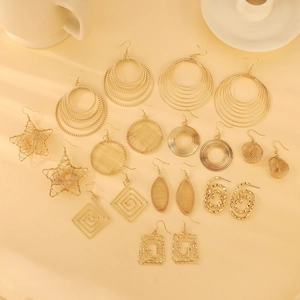 Set of 10 pairs of geometric hollow gold earrings featuring stars and spiral designs