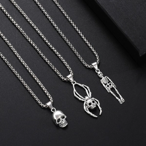 Detailed view of punk style gothic silver necklaces featuring skull and skeleton pendants