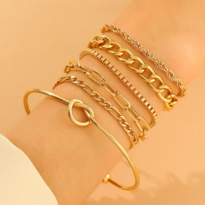 Close-up of a 6-piece golden alloy bracelet set featuring knot cuff and link chains