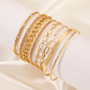 Minimalist gold alloy knotted bracelet set featuring geometric cross designs on white stand