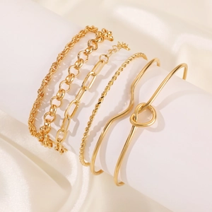 Detail of a six-piece gold-toned alloy bracelet set including knot and chain designs