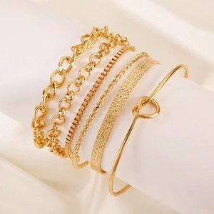 Detailed close-up of a 6-piece golden alloy knot bracelet set on a white silk background
