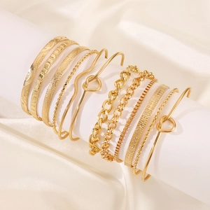 Detailed close-up of gold alloy knotted bracelet set featuring various geometric designs