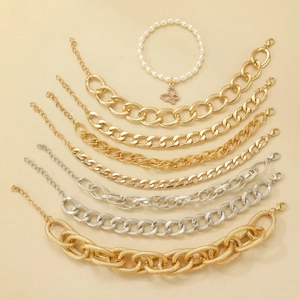 Detailed set of eight gold and silver chain bracelets with pearl and butterfly charms