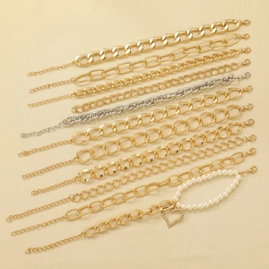 Detailed flat lay of assorted gold and silver alloy knot bracelets with pearl heart charms