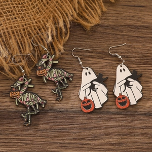 Detail view of gothic wooden Halloween earrings featuring mummy flamingos and cute ghosts