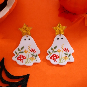 Detail of acrylic ghost earrings with floral patterns and gold star for Halloween decor