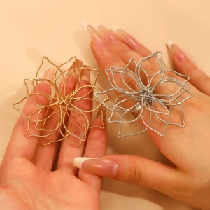 Detail of layered woven lotus flower rings in gold and silver finish on hands