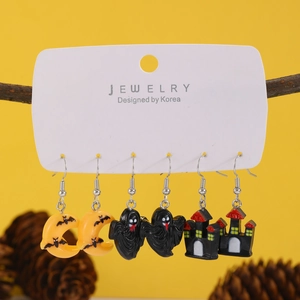 Halloween earring set with crescent moons ghosts and haunted houses on tree branch display