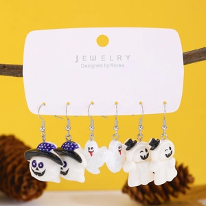 Three pairs of cute Halloween ghost earrings on a yellow background with branch detail