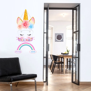Detail of unicorn wall sticker featuring rainbow ribbons and 3D paper flower accents