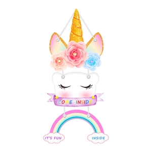 Detailed view of cartoon unicorn and rainbow wall hanging decoration in macaron colors