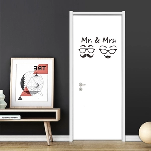 Detail of Mr. & Mrs. vintage glasses and lips wall sticker on a white interior door