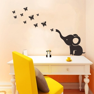 Detail of cartoon elephant and butterflies wall decals applied on a clean white interior wall
