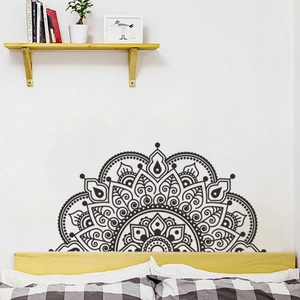 Detailed black semi-circle mandala wall decal above a minimalist bed headboard