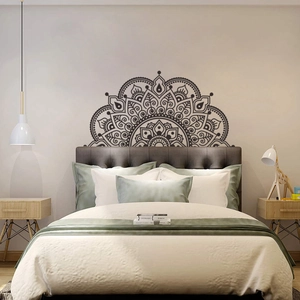 Detail of a black semi-circular mandala wall sticker used as a bedroom headboard decor