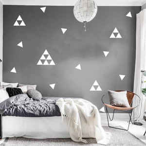 Modern white geometric triangle wall decals on a dark grey bedroom wall for home decor