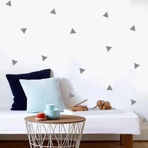 Detail of grey geometric triangle wall stickers applied on a modern nursery room wall