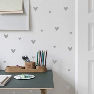Detail of matte grey heart wall stickers in various sizes for minimalist nursery decor