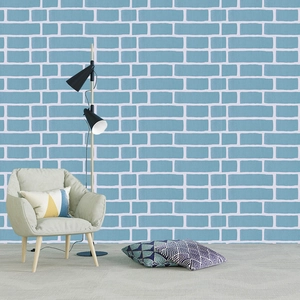 Detailed view of light blue brick pattern self-adhesive wallpaper in a cozy living room