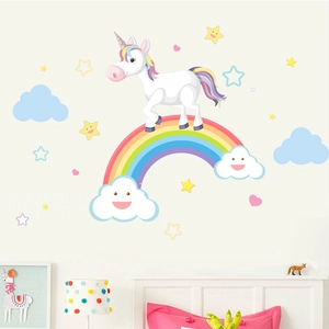 Detail of cartoon rainbow unicorn wall stickers in a cozy child bedroom setting