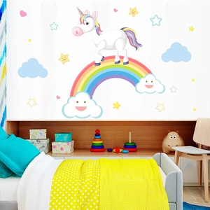 Vibrant cartoon rainbow unicorn wall stickers in a cozy child bedroom setting