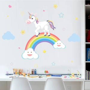 Detail view of cartoon unicorn and rainbow wall decals on a child's white playroom wall