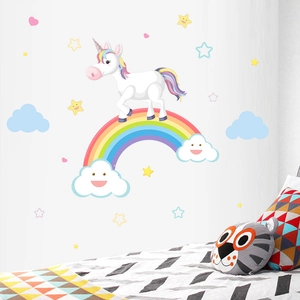 Detail showing a colorful cartoon unicorn and rainbow wall sticker for a nursery room