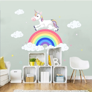 Detail view of colorful unicorn and rainbow wall decals in a child's bedroom setting