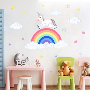 Detail of colorful rainbow and cartoon unicorn wall stickers in a cozy child's bedroom